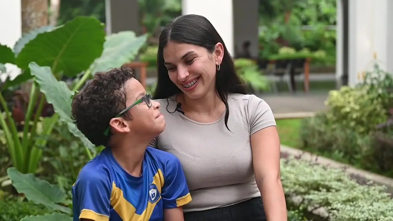 Fernanda Garcia and her son smiling at each other in the school garden