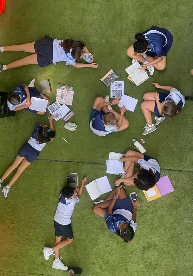 Students collaborating in a circle outdoors